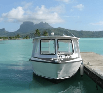 tropical lagoon with small ferry in foreground